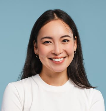 Input portrait A: a smiling adult woman in a white T-shirt against a blue background.