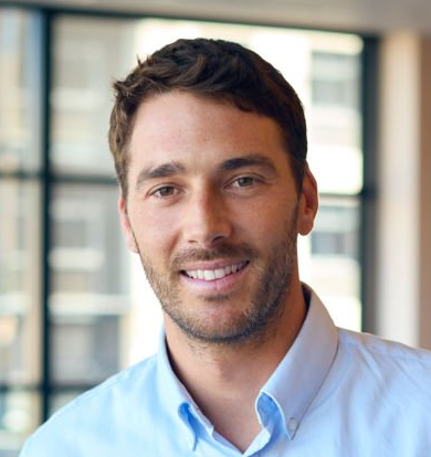 Input portrait B: a smiling adult man wearing a light blue collared shirt.